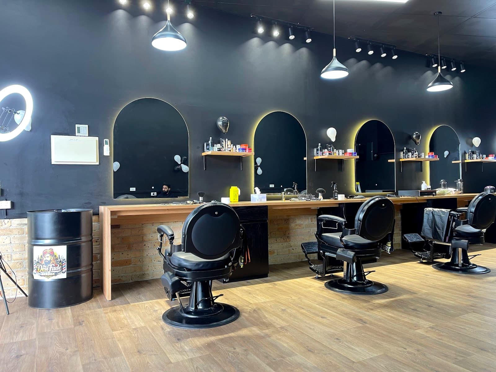Wide view of the five cutting stations with arched mirrors and pendant lighting